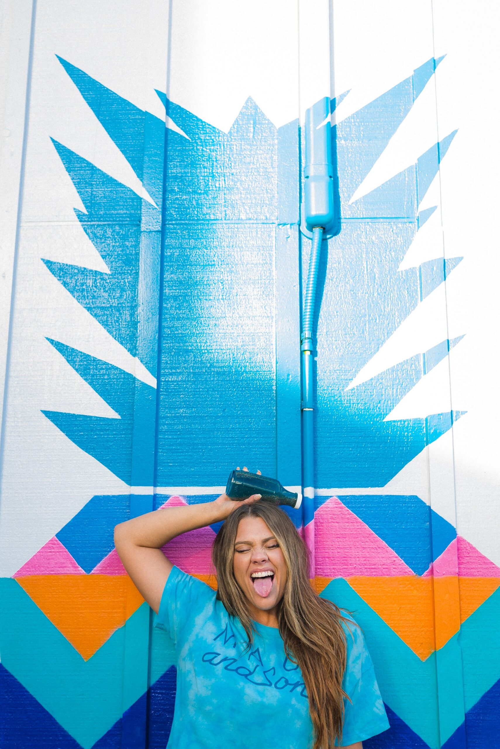 Woman in front of a mural